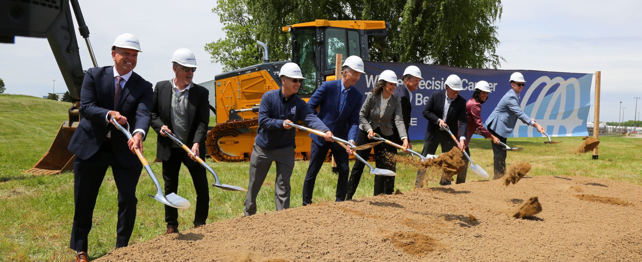 Governor Whitmer and others shovel dirt at the groundbreaking of the Niowave expansion site